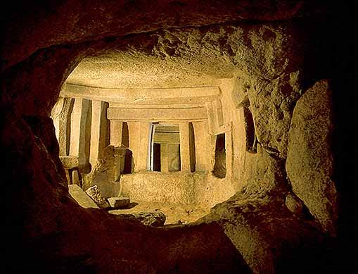 The Holy of Holies chamber inside the Ħal Saflieni Hypogeum, Malta, showing carved limestone columns and trilithon doorways